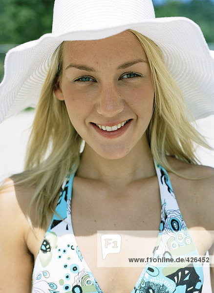 Portrait of a woman wearing a sun hat.