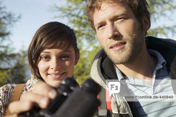 Young couple  man holding binocular