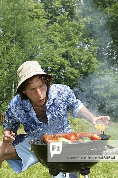 A man barbecuing.