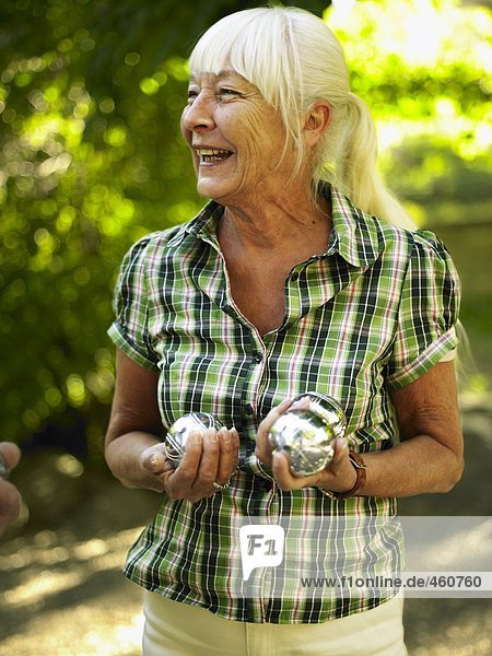 Woman playing boule.