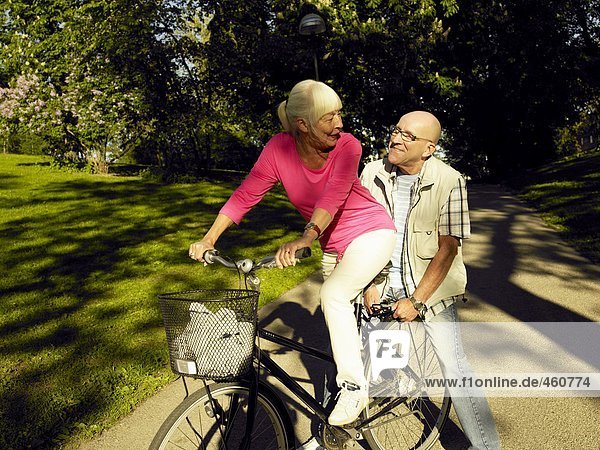 A couple on a bicycle.