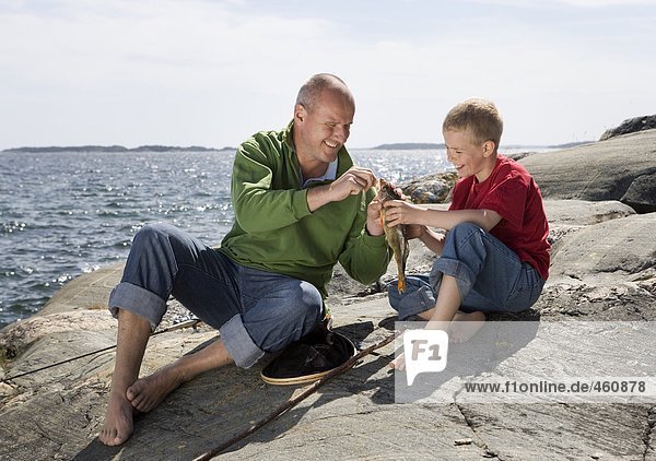 Father and son with caught fish.