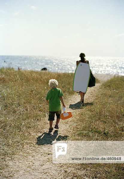 Mother and son on their way to the beach.