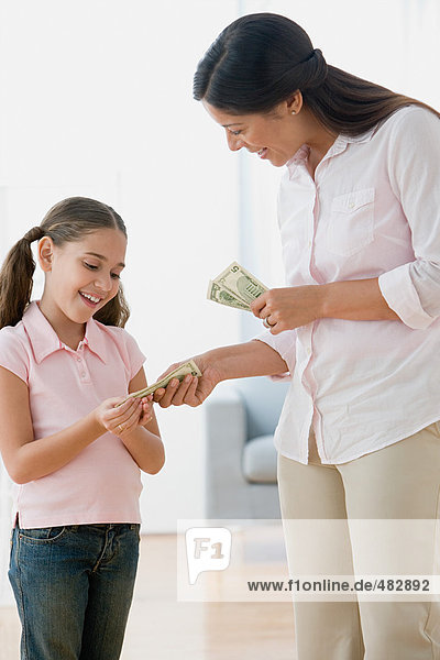 Mother giving daughter pocket money