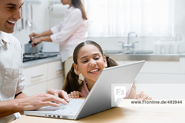 Vater und Tochter mit einem Laptop-Computer