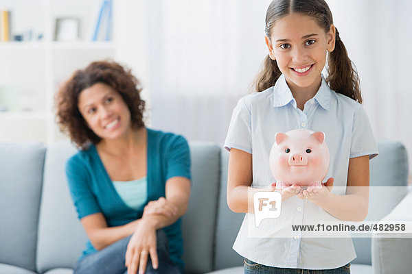 Girl holding a piggy bank