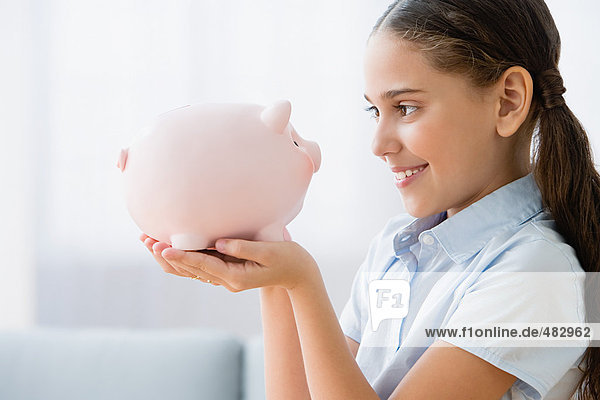 Girl holding a piggy bank