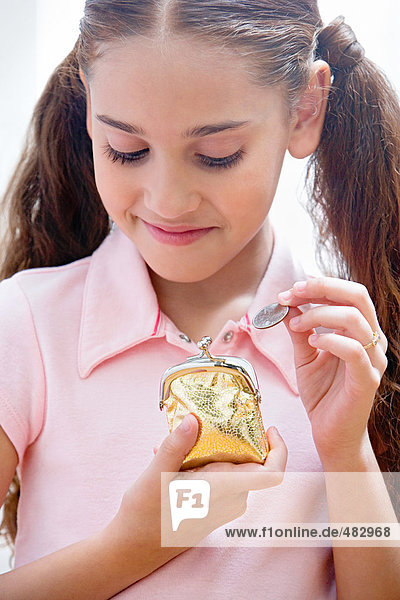 Girl holding a coin and purse