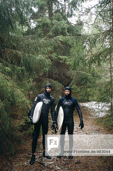 Two surfer in the forest.