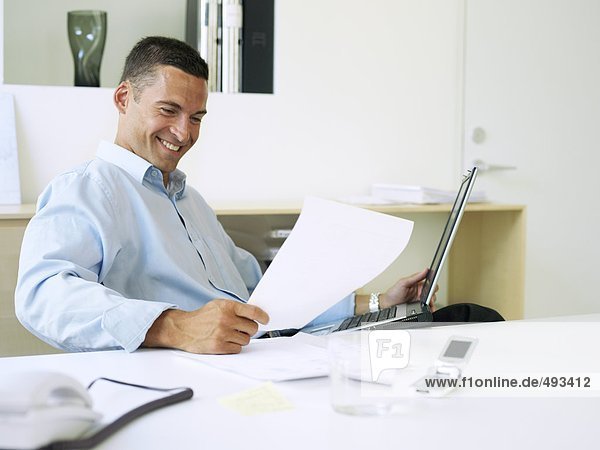 A smiling man in an office.
