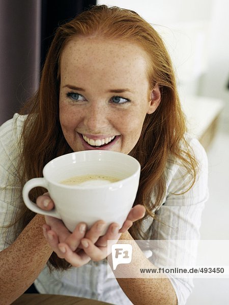 Portrait of a young woman drinking tea.