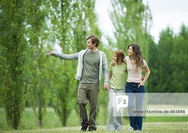 Young family going for walk  man pointing