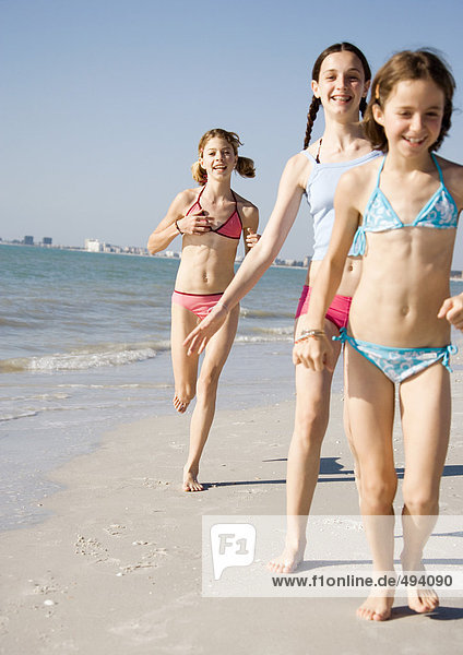 Mädchen beim Laufen und Spazierengehen am Strand