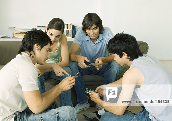 Group of young adult friends looking at photos