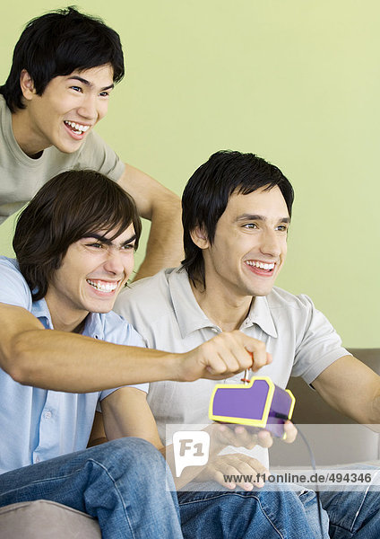 Three young men playing video games