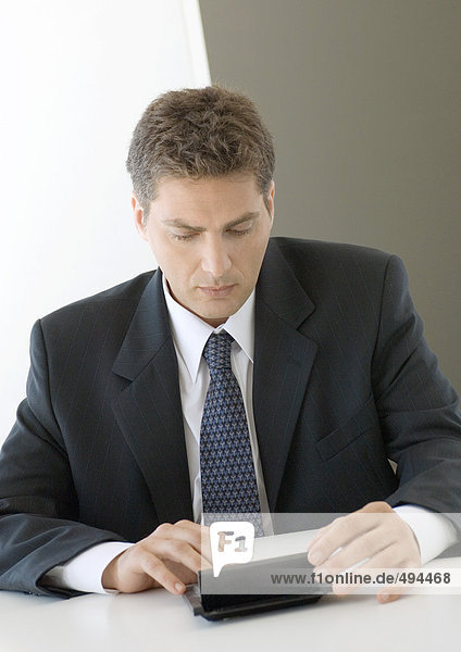 Businessman using pocket computer