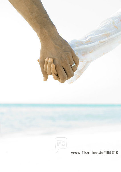 Ehepaar hält Hände am Strand  Nahaufnahme der Hände
