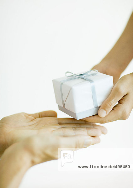 Hands giving and receiving gift