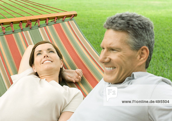 Mature couple lounging in hammock