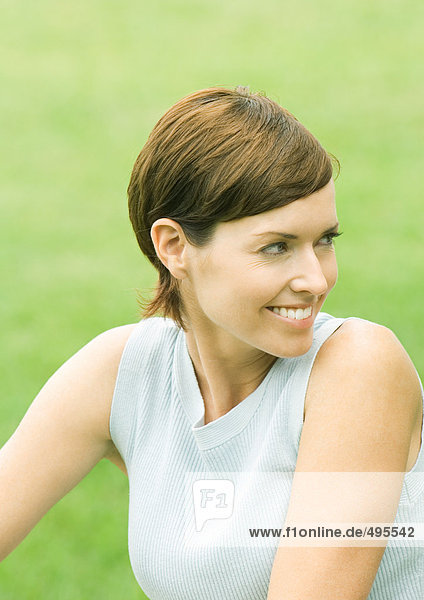 Woman looking over shoulder  smiling