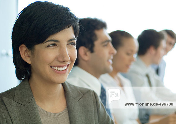 Business colleagues having meeting  focus on woman in foreground