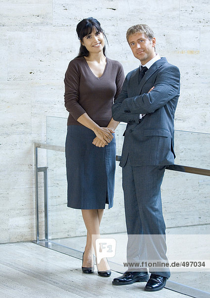 Geschäftsmann und Frau  stehend und lächelnd  Portrait