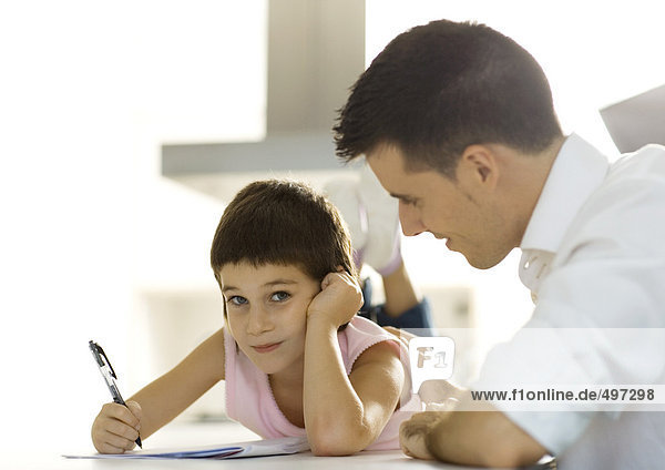 Father helping child with homework