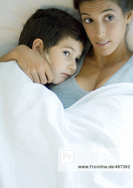 Child lying down with head on mother's shoulder