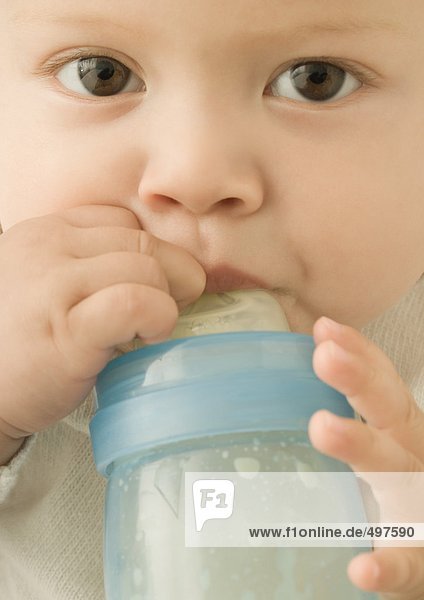 Baby drinking from baby bottle