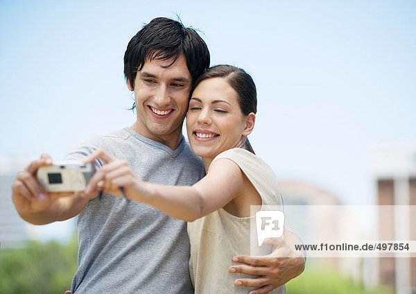 Young couple taking picture of themselves together