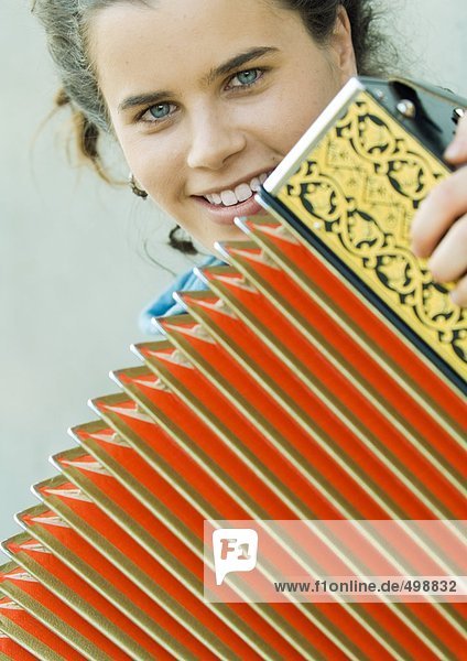 Young woman playing accordian