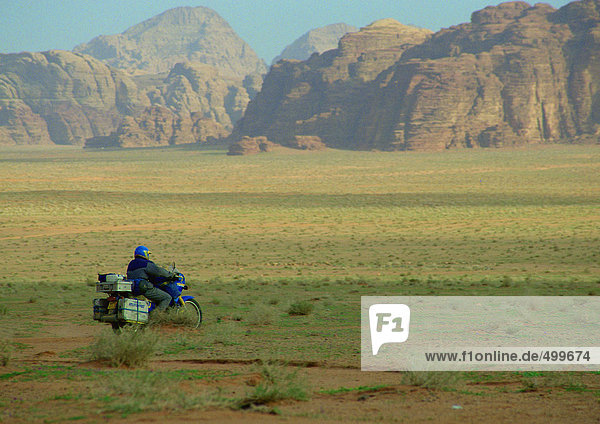 Jordan  motorcyclist riding through mountainous region