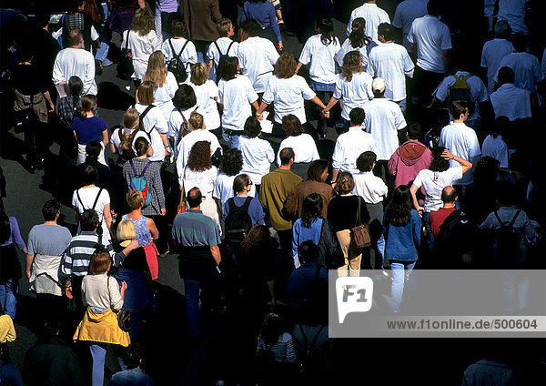 Crowd of people  many in white shirts  high angle view