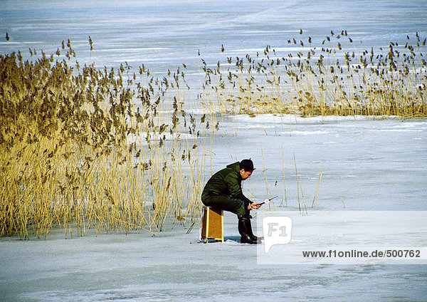 Sweden  person fishing on frozen water