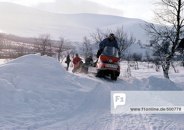 Sweden  snowmobiles on snowy landscape