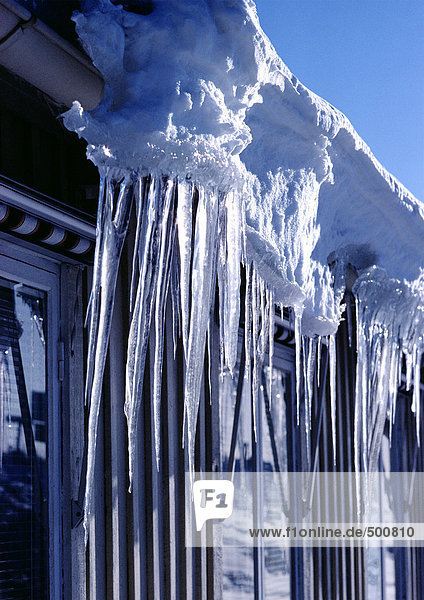 Sweden  icicles hanging from edge of house  close-up