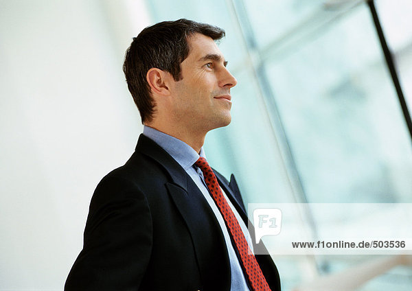 Businessman smiling  looking away  side view