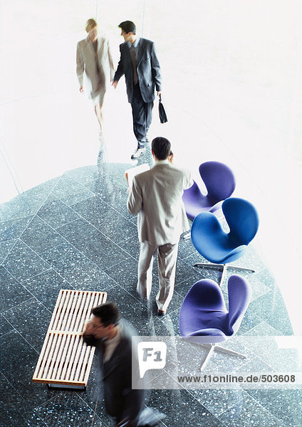 Business people standing in lobby  elevated view