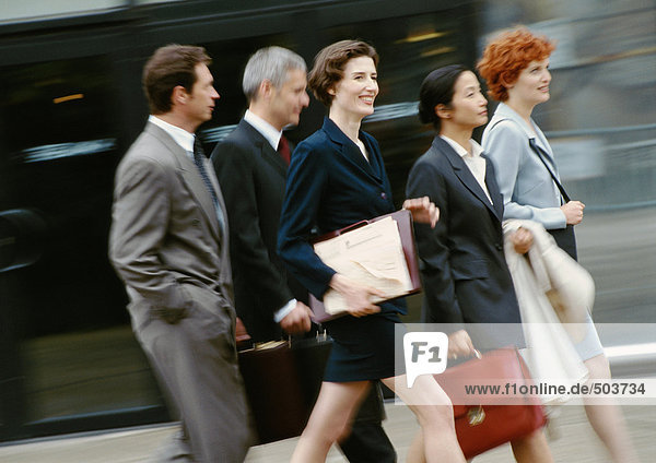 Group of business people walking  blurred