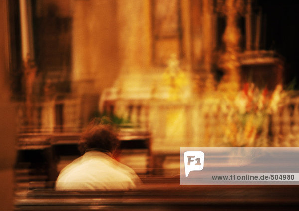 Person sitting in a church  blurred