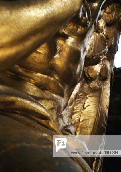 Gilded statue  mid section  low angle view  close-up