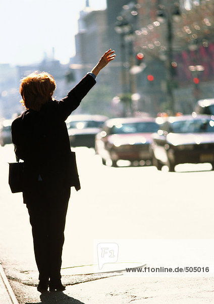 Woman in street  raising arm