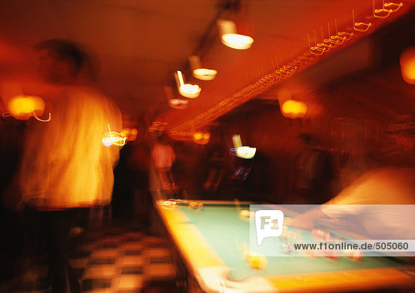 People playing pool  blurred