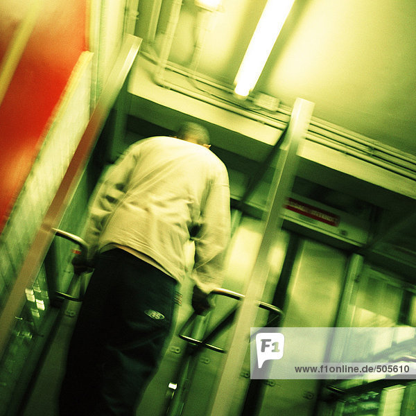 Junger Mann vor der U-Bahn-Ausgangstür  Rückansicht  Tiefblick