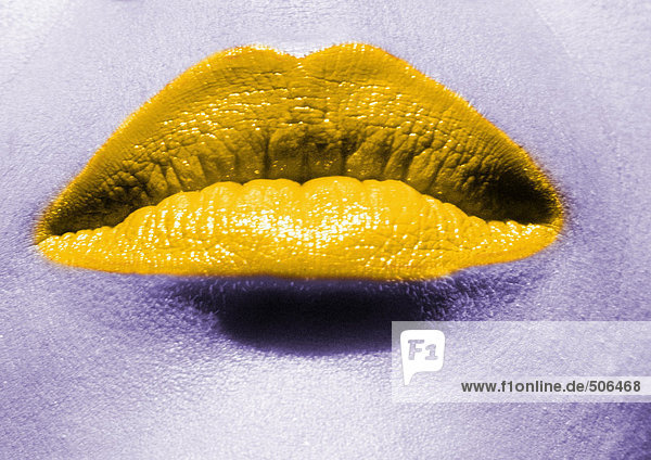 Close up of woman's mouth with yellow lipstick. mouth