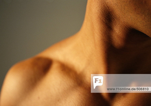 Man's bare neck and shoulder  close-up
