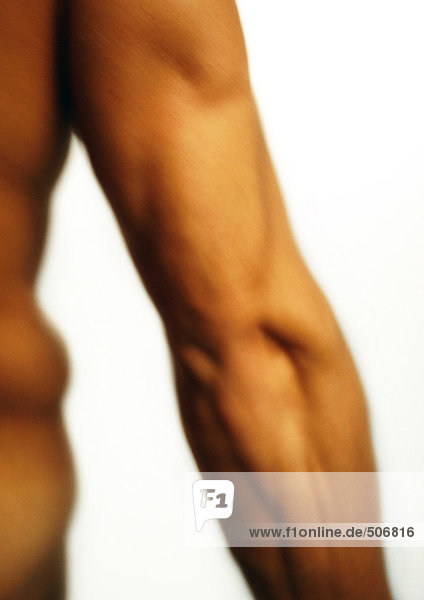 Man's flexed triceps  blurred  close-up.