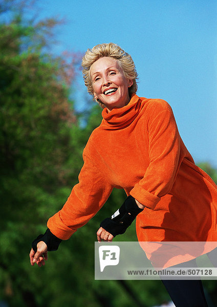 Mature woman smiling  in-line skating