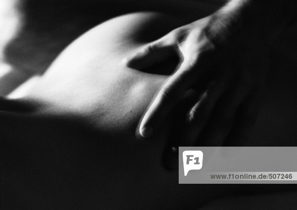 Man's hand on woman's buttocks  black and white.