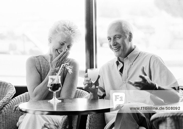 Mature man and woman talking in a cafe  B&W